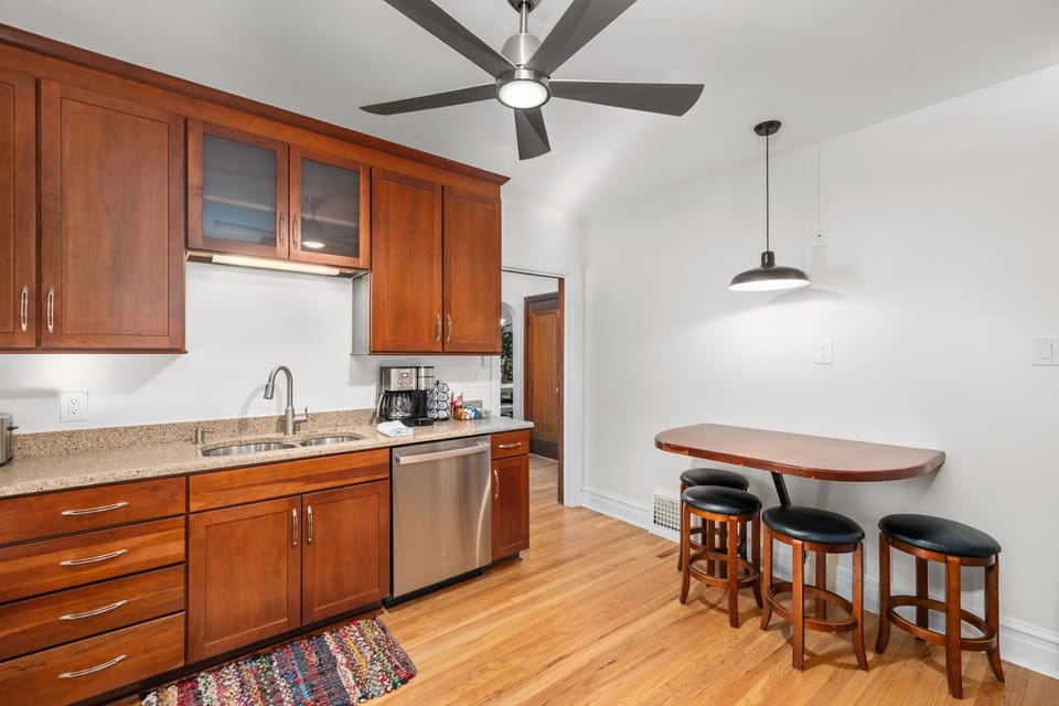 Kitchen with gas range, microwave, dishwasher, full kitchen utensils, plates, bowls, (kids cups and dishes), toaster, blender, waffle maker, and cookware.  Additional dining space for 4.