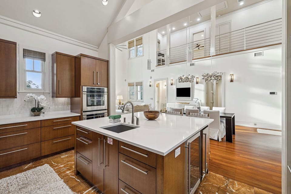 Cook in this stunning open-concept kitchen featuring sleek cabinetry, pristine countertops, and high-end appliances that flow seamlessly into your elegant living space.