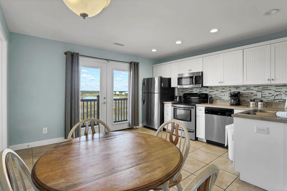 Bright dining space with seating for meals and direct access to the private balcony—perfect for morning coffee or sunset dinners 