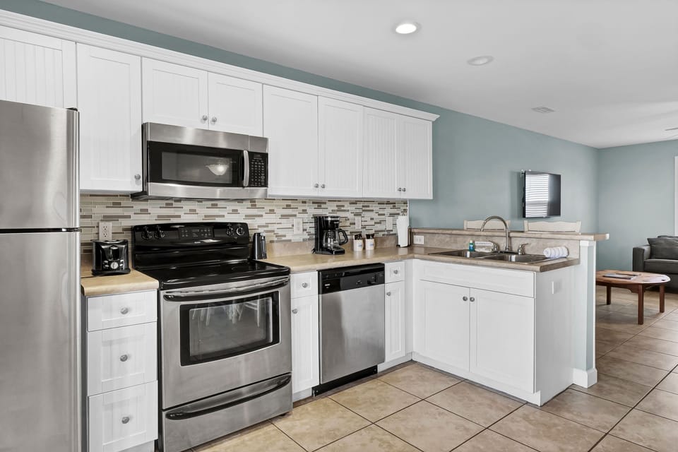 Full kitchen with stainless steel appliances, ample cabinetry, and modern finishes; ideal for cooking, reheating, or longer stays