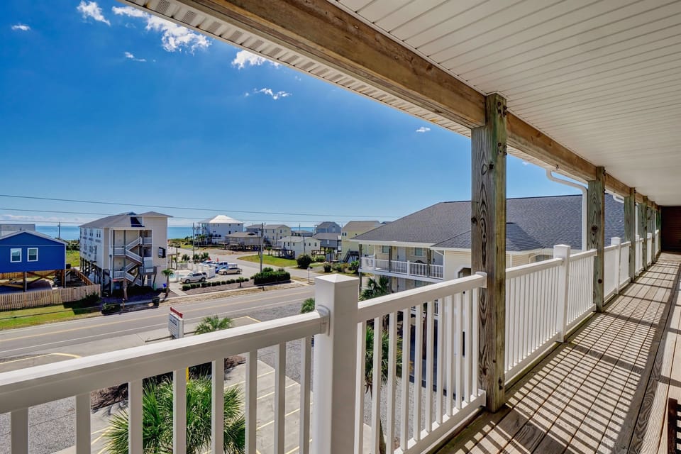 Private balcony overlooking the quiet Surf City neighborhood—perfect for morning coffee, ocean breezes, and relaxing between beach outings