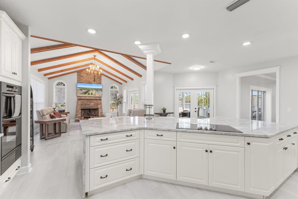 Custom kitchen with granite counters and views to the family room.