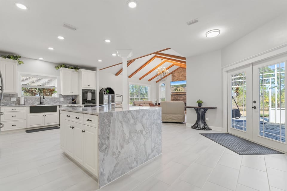 Spacious chef’s kitchen with doors to the screened lanai...perfect for entertaining inside and out!