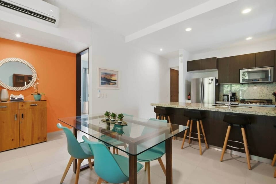 Enjoy meals together in the modern dining area with seating for 4, perfectly positioned next to the kitchen island for easy entertaining and relaxed gatherings.