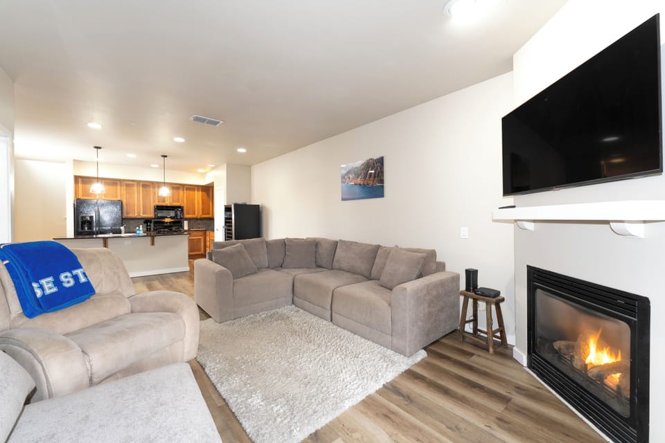 Cozy up on the couch next to the fireplace. | Main Level