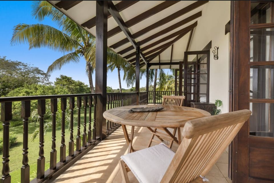 Upstairs terrace looking out the trees and towards the sea