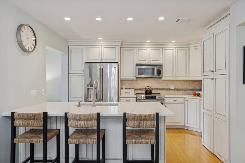 Crisp cabinetry, ample counter space, and modern appliances make cooking effortless.