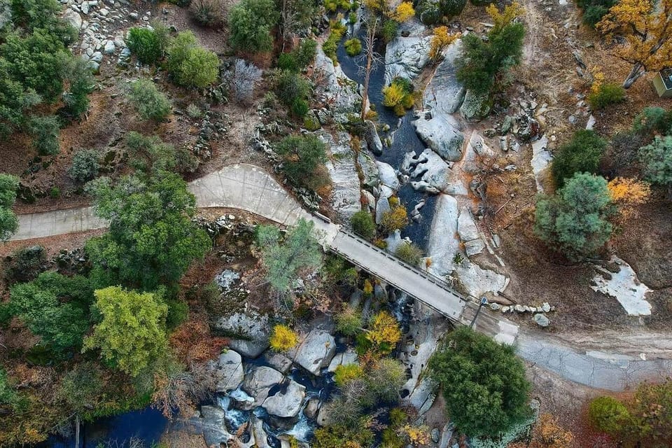 Private gated bridge over the river. As you drive across you will be welcomed w/cascading waterfalls