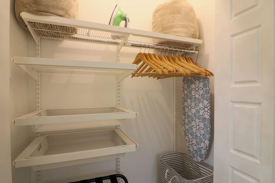 Each bedroom includes closet space with wooden hangers, shelving, luggage rack, extra blankets, and convenient storage to keep your stay organized and comfortable.