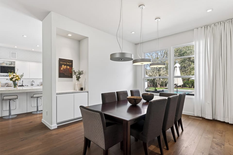 Sleek formal dining space with statement lighting and garden views—ideal for intimate dinners or elevated wine-country gatherings.