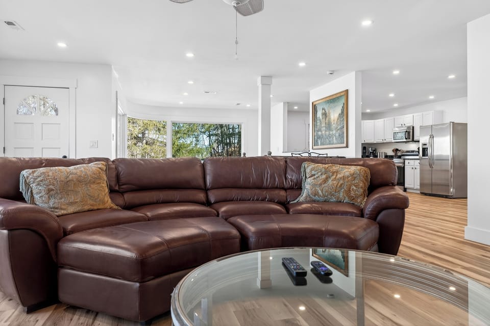 Cozy mountain-view living room with a stone fireplace and a big-screen TV for movie nights.
