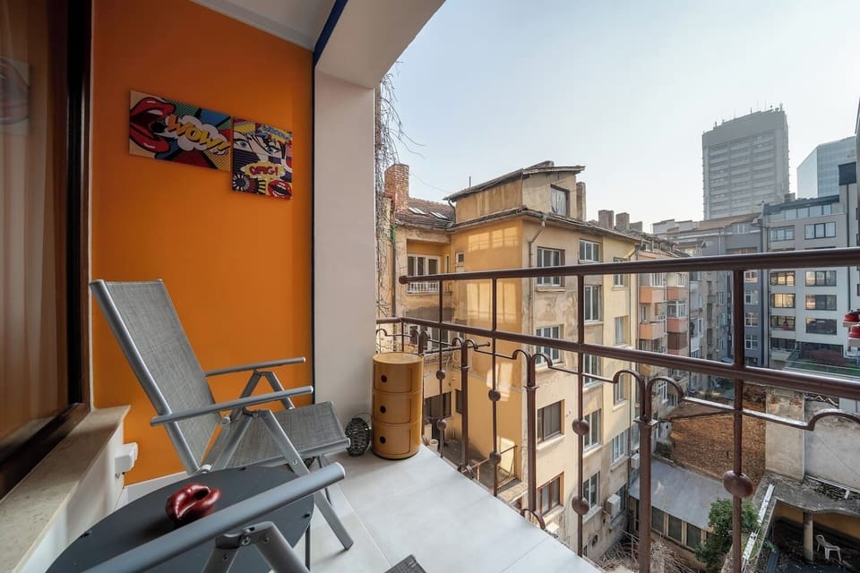 Your private slice of Sofia — a sunny south-facing balcony where the city's rooftops stretch out in every direction