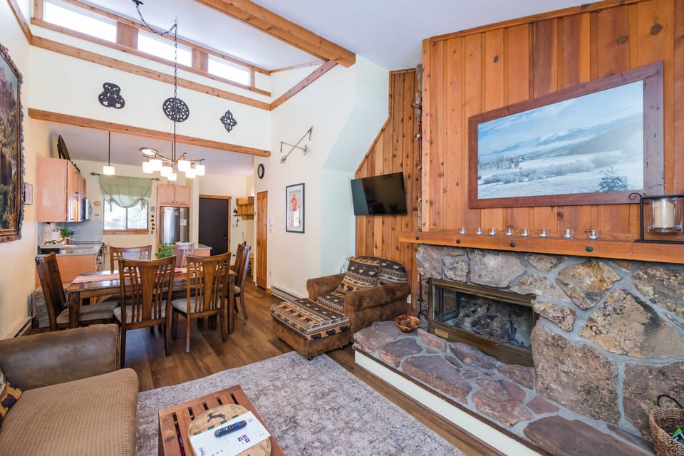 Cozy up by your stone fireplace while winter views fill the picture window in this warm mountain retreat.