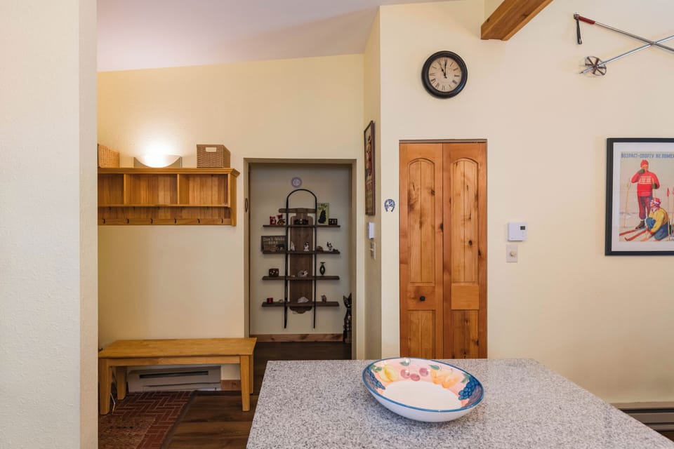 Step into your cozy kitchen where warm wood details and thoughtful storage create the perfect space for preparing mountain meals.