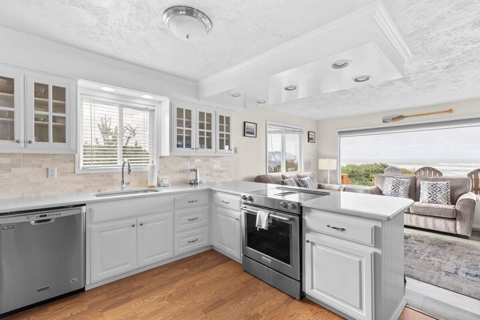 Your bright, fully-equipped kitchen flows into a cozy living area, perfect for preparing meals while enjoying stunning views.