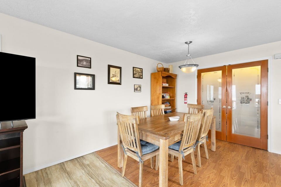 Gather around this warm wooden dining table for memorable meals with your group, complete with TV entertainment nearby.