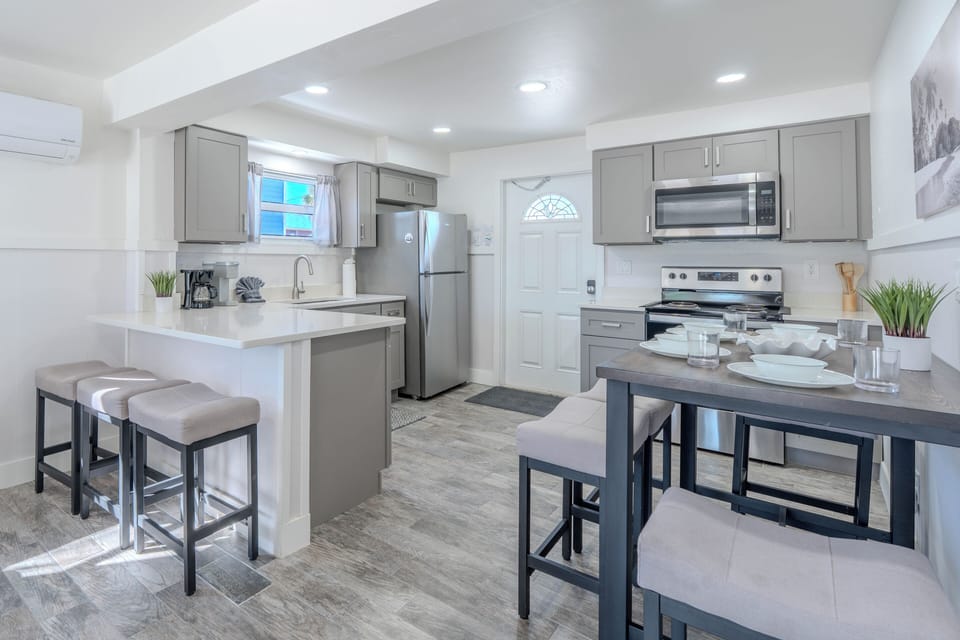 Open-concept kitchen, breakfast bar, and dining area.