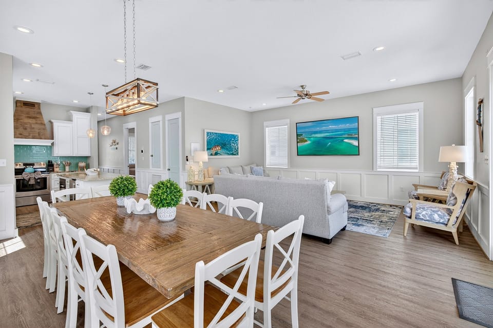 1st Floor - Generous dining space with seating for 12 at the main table, 4 at the kitchen island, and 12 more at the outdoor dining table—perfect for large group meals, celebrations, and gathering together indoors or outside.