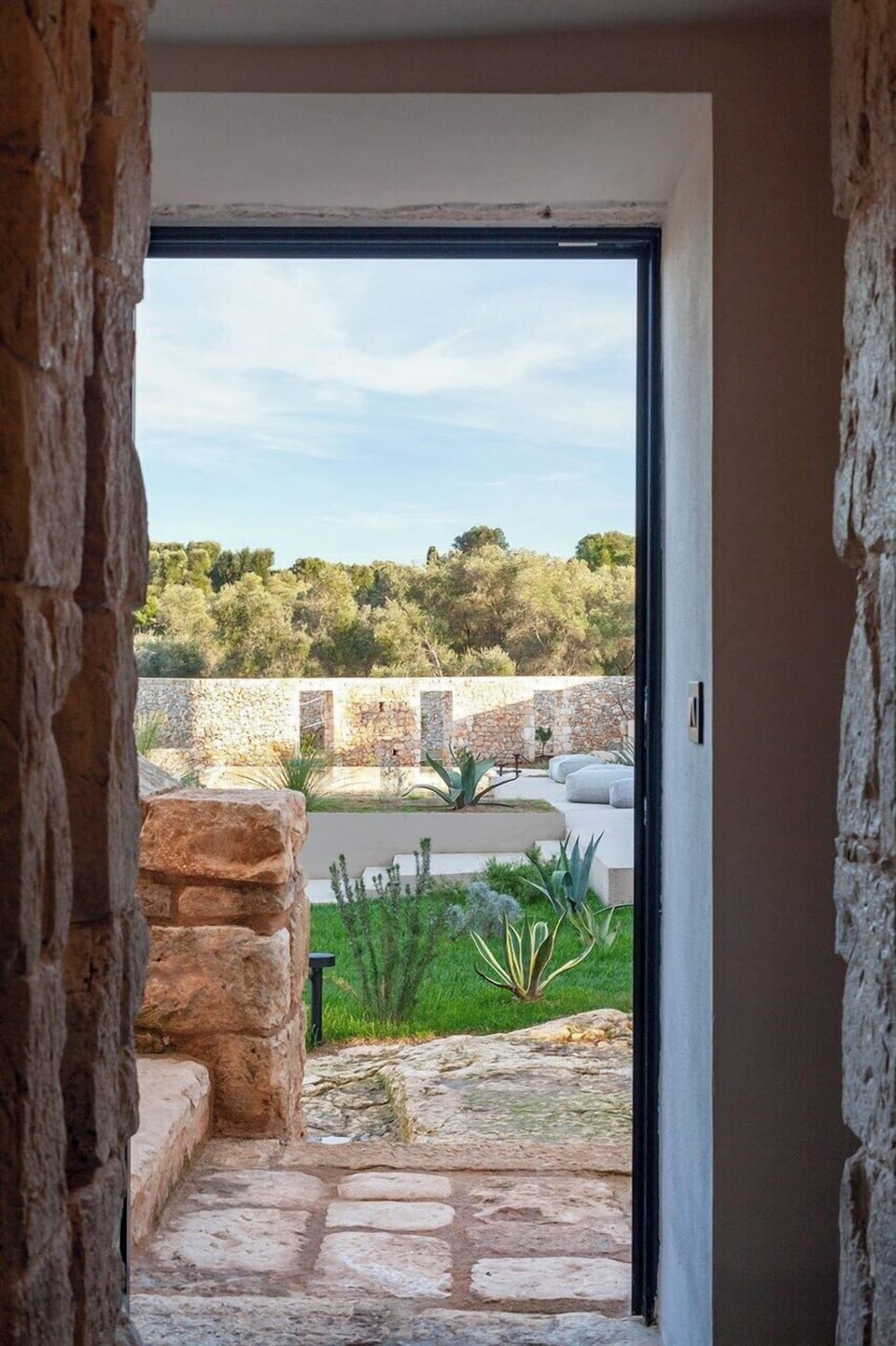 Looking out of the second bedroom to the terraces and pool area.
