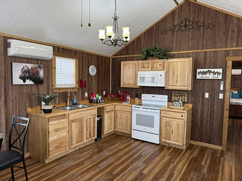 Fully equipped kitchen with full-size appliances, ample counter space, and warm wood cabinetry-ideal for home-cooked meals during your stay