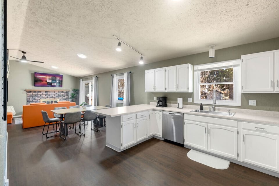 Spacious open layout featuring a cozy living area, dining space, and fully equipped kitchen