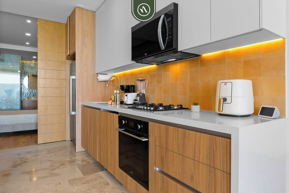 Prepare meals with ease in the modern kitchen, complete with full-size appliances, cookware, and everything you need for a convenient stay by the beach.