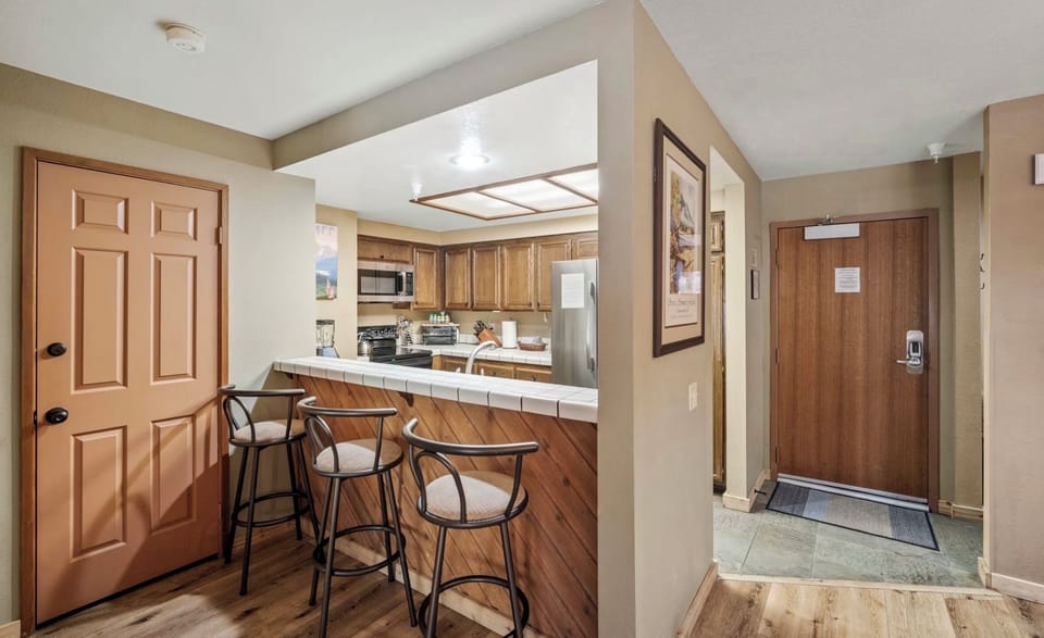 Relax in open-plan kitchen, bar seating perfect for morning coffee & socializing