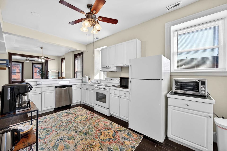 A clean, airy kitchen with modern appliances and charming details—both functional and effortlessly inviting.