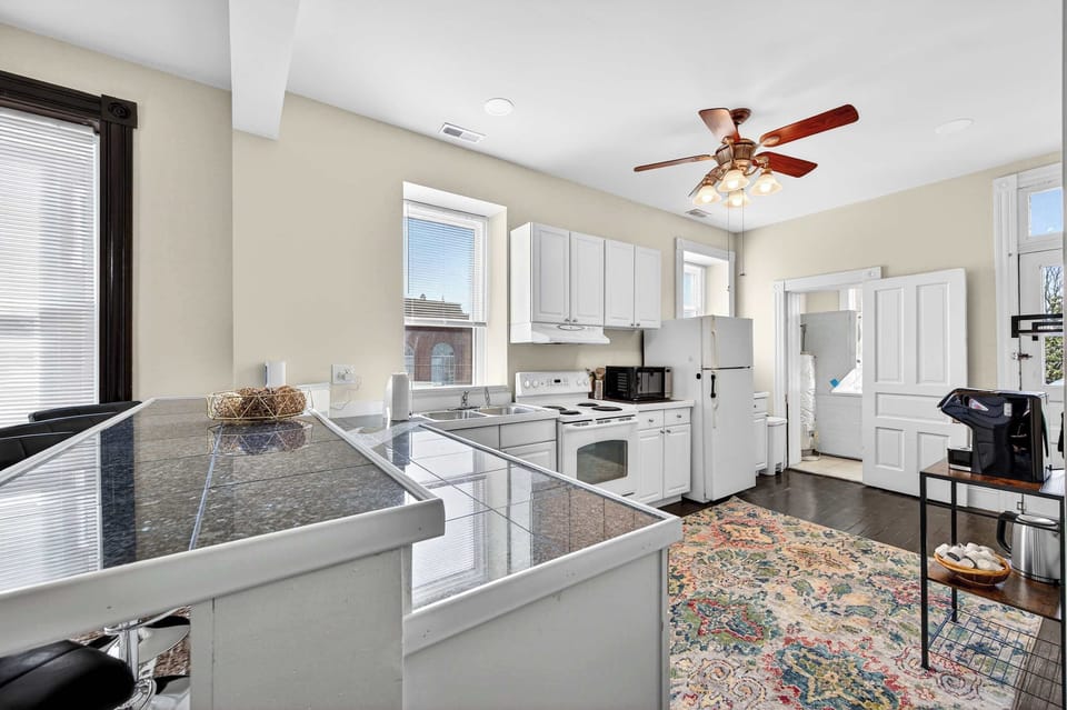 Bright and beautifully styled kitchen with ample counter space, bar seating, and everything you need to cook, sip, and stay awhile.
