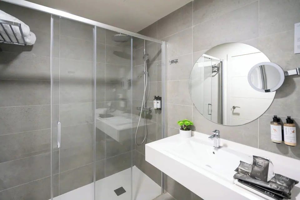 Refresh under a rainfall shower in a spotless modern bath.