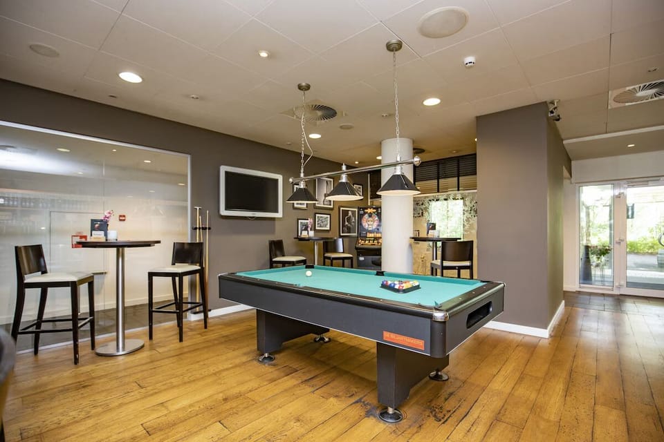 Challenge friends to a playful game night by the pool table.