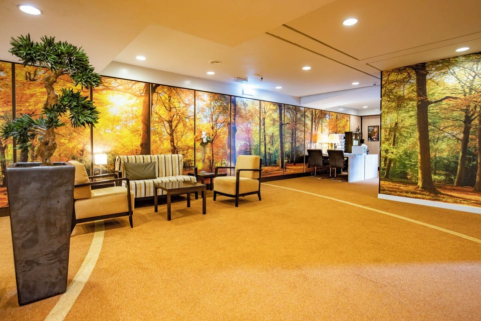 Relax into plush seating beneath warm, calming forest murals.