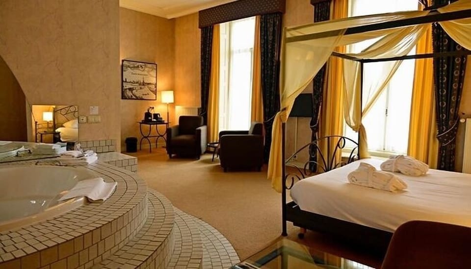 Indulge in a romantic suite with canopy bed and whirlpool.