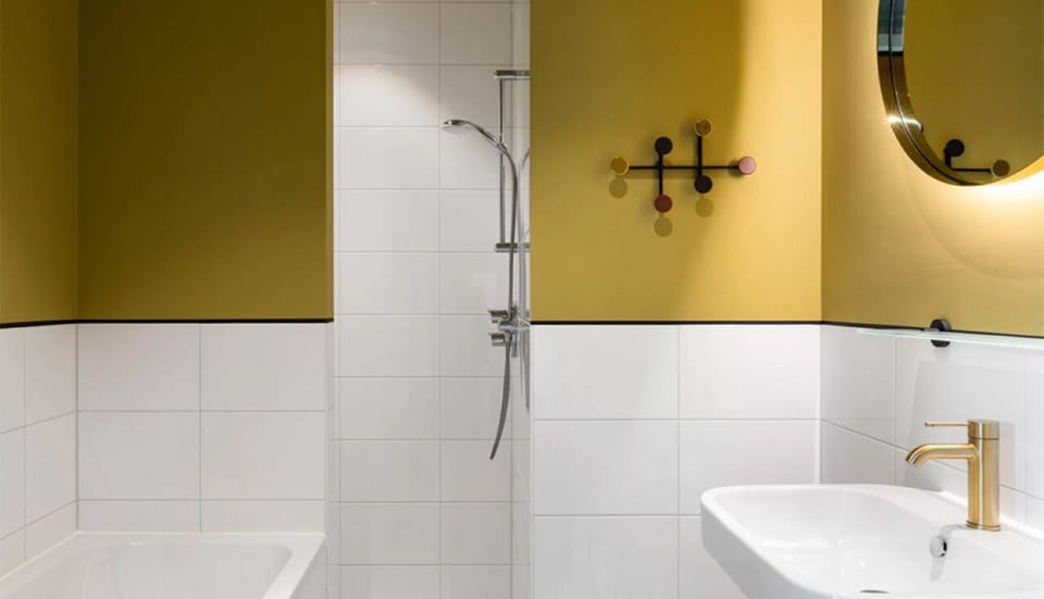 Refresh under the rainfall shower beside a bright, modern vanity.