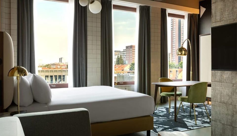 Wake up to city views beside a chic work table.