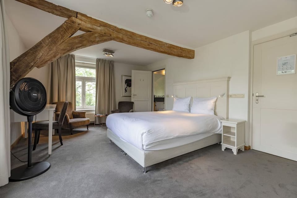 Wake up in a spacious suite with charming exposed beams.