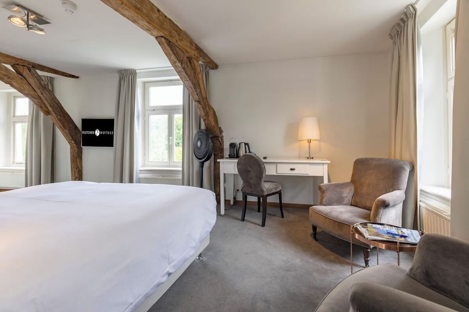 Unwind on crisp linens beneath rustic beams and soft light.