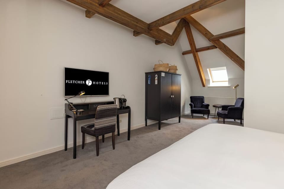 Unwind beneath rustic beams with a cozy lounge corner.