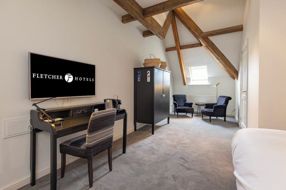 Settle in with a dedicated desk, TV, and cozy chairs.