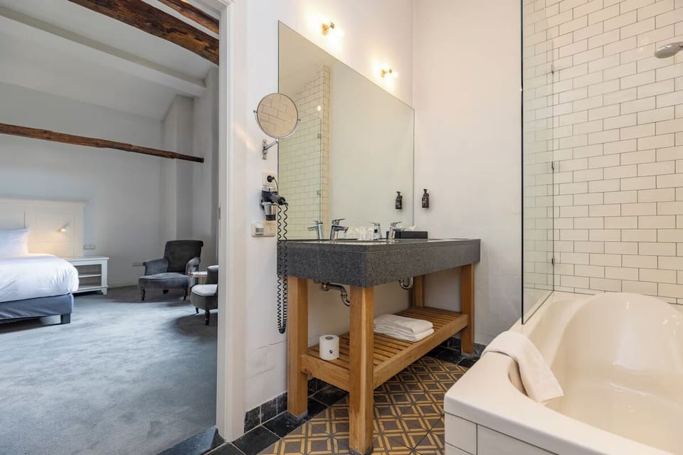 Unwind with a long soak in the bright tiled bath.