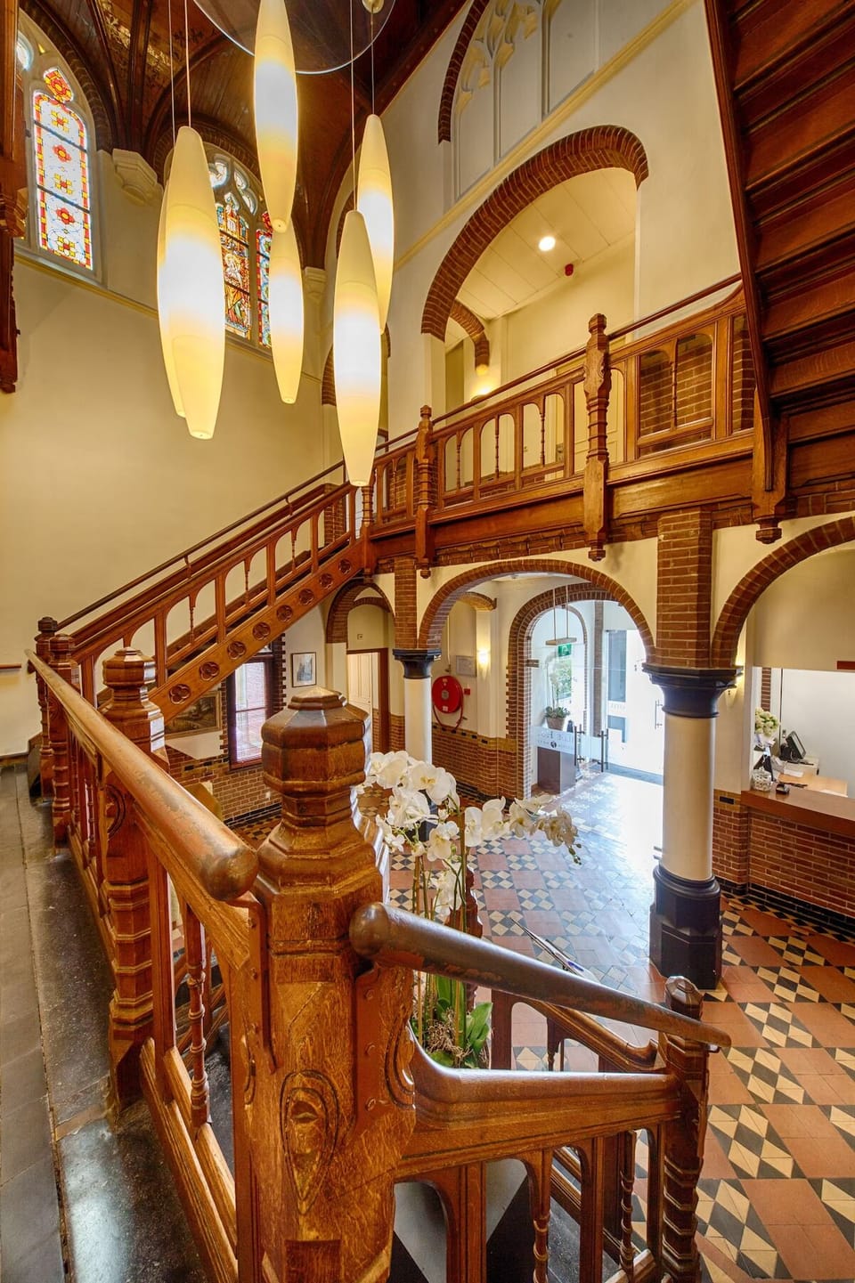 Admire the dramatic staircase and glow of the open atrium.