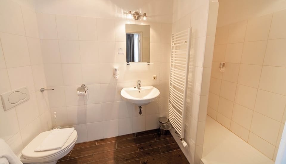 Enjoy a clean, airy bathroom with plenty of room.