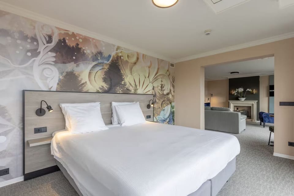 Unwind in a serene king bed beneath artistic murals.