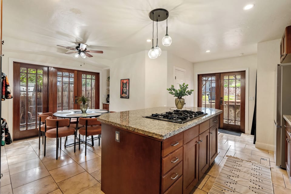 Kitchen - Exquisite kitchen with contemporary lighting fixtures, and dining table for easy conversations pre-meal, during or after.
