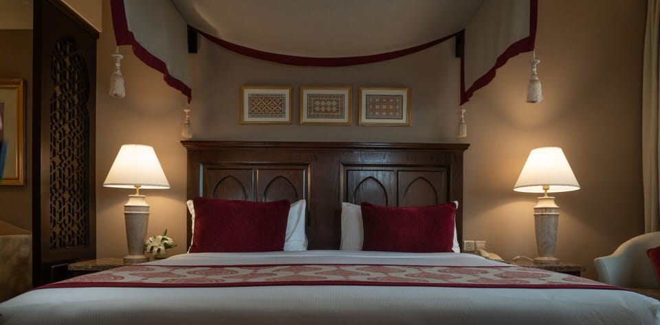 Sink into a plush canopy bed framed by soft, glowing lamps.
