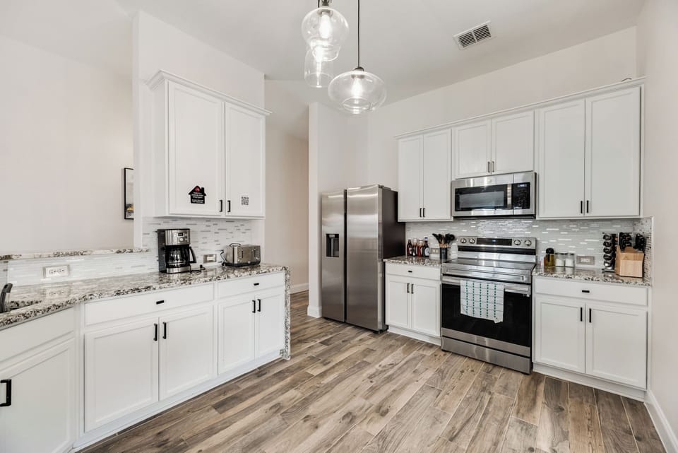 Fully stocked kitchen with utensils, coffee & rice maker, blender & toaster
