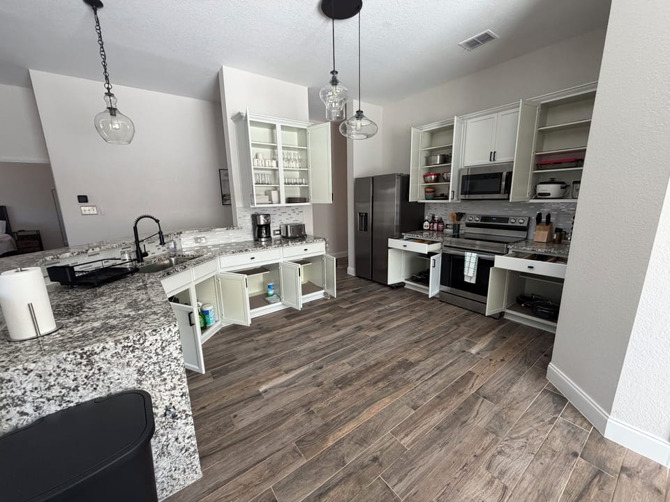 Fully stocked kitchen with utensils, coffee & rice maker, blender & toaster