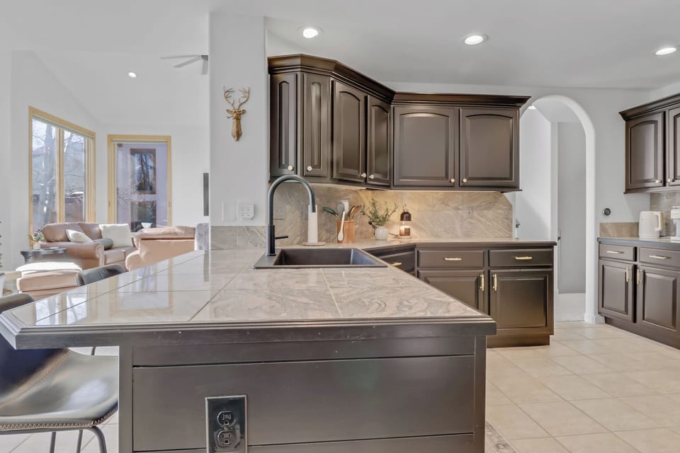 Your spacious gourmet kitchen features marble countertops, premium appliances, and elegant cabinetry—perfect for preparing memorable meals during your stay.