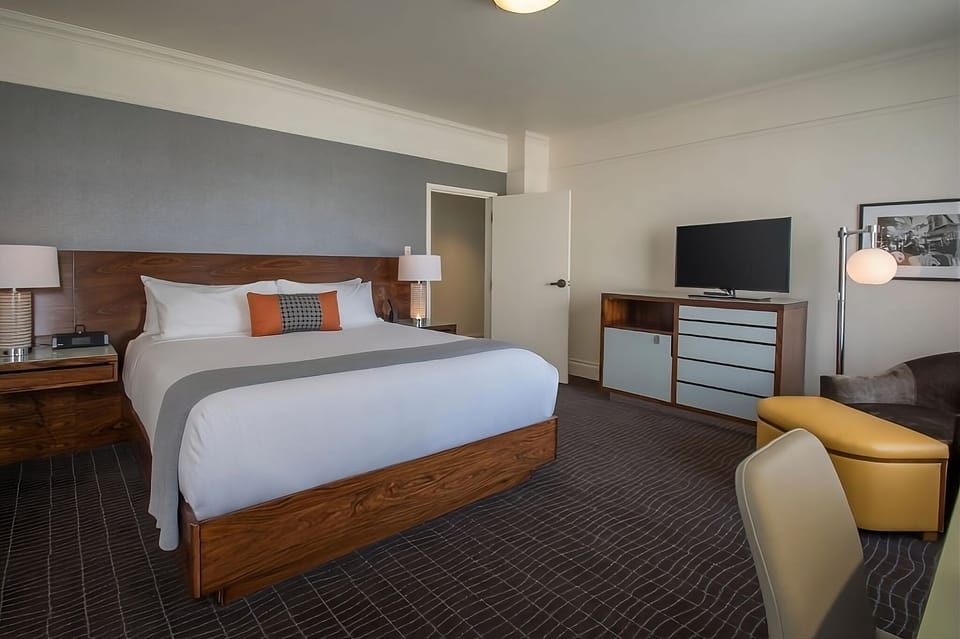 Unwind in a serene king bedroom with warm, modern accents.