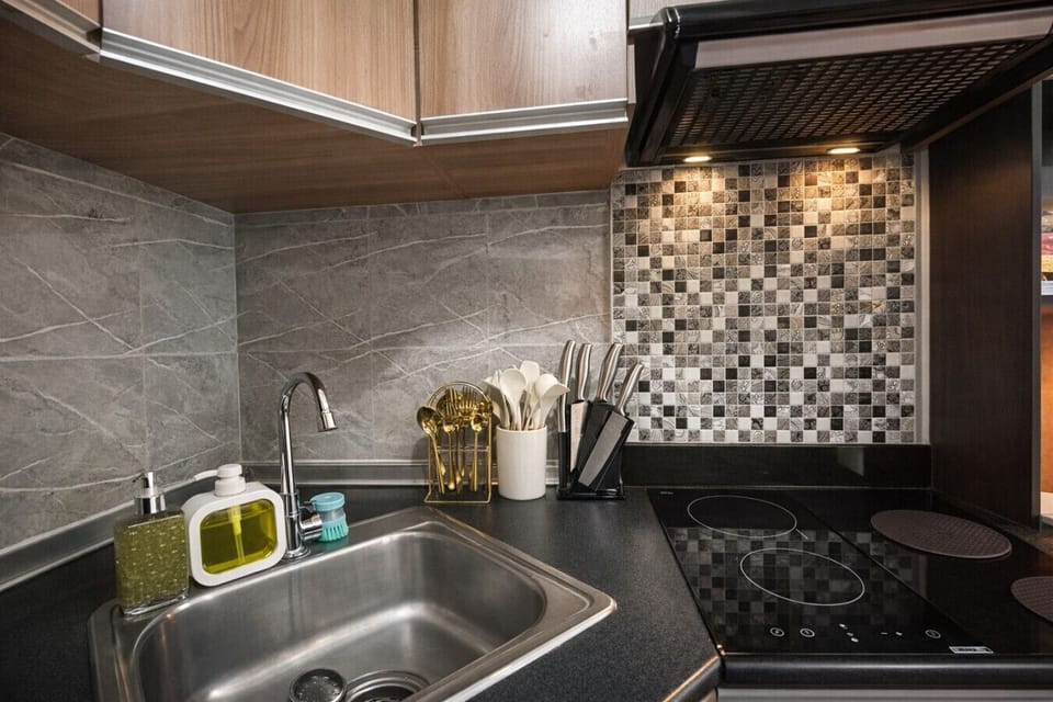 Cook with ease—fully equipped kitchenette with cooktop, sink, utensils, and dishwashing essentials provided